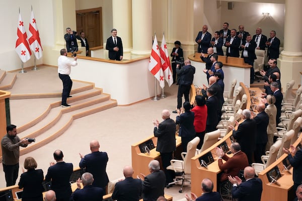 Georgian president-elect Mikheil Kavelashvili is greeted by the electoral college members at the Georgian parliament, in Tbilisi, Georgia, Saturday. Dec. 14, 2024. (AP Photo)