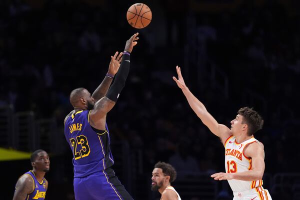 Los Angeles Lakers forward LeBron James (23) shoots as Atlanta Hawks guard Bogdan Bogdanovic (13) defends during the second half of an NBA basketball game, Friday, Jan. 3, 2025, in Los Angeles. (AP Photo/Mark J. Terrill)