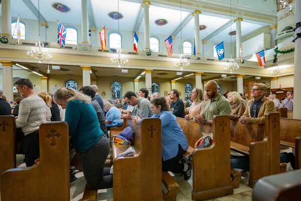 Parishioners pray at St. Louis Cathedral during a mass by Father Patrick Williams about the victims of the New Year's Day deadly truck attack and shooting on Bourbon Street not far from the cathedral in the French Quarter in New Orleans, Sunday, Jan. 5, 2025. (AP Photo/Matthew Hinton)