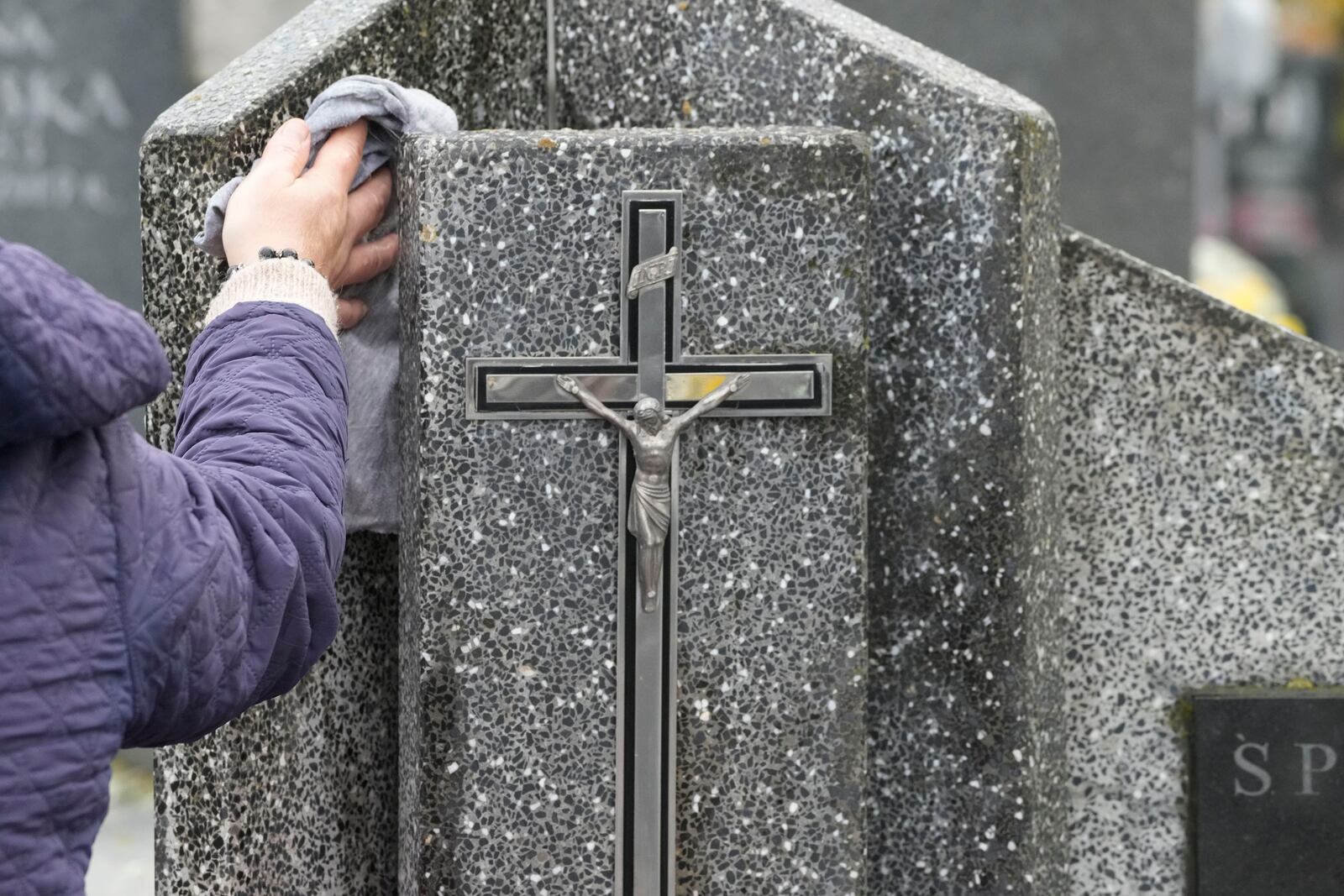 People prepare for All Saints' Day at the cemetery in Zakroczym, near Warsaw, Poland, Wednesday, Oct. 30, 2024. (AP Photo/Czarek Sokolowski)