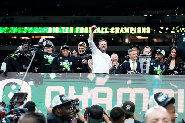 Oregon head coach Dan Lanning, center, celebrates with his team after the Big Ten championship NCAA college football game against Penn State, Saturday, Dec. 7, 2024, in Indianapolis. (AP Photo/AJ Mast)