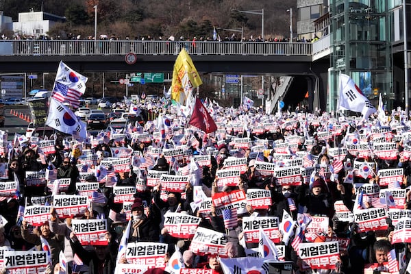 Supporters of impeached South Korean President Yoon Suk Yeol stage a rally to oppose a court having issued a warrant to detain Yoon, near the presidential residence in Seoul, South Korea, Thursday, Jan. 2, 2025. The signs read, "Oppose impeachment." (AP Photo/Ahn Young-joon)