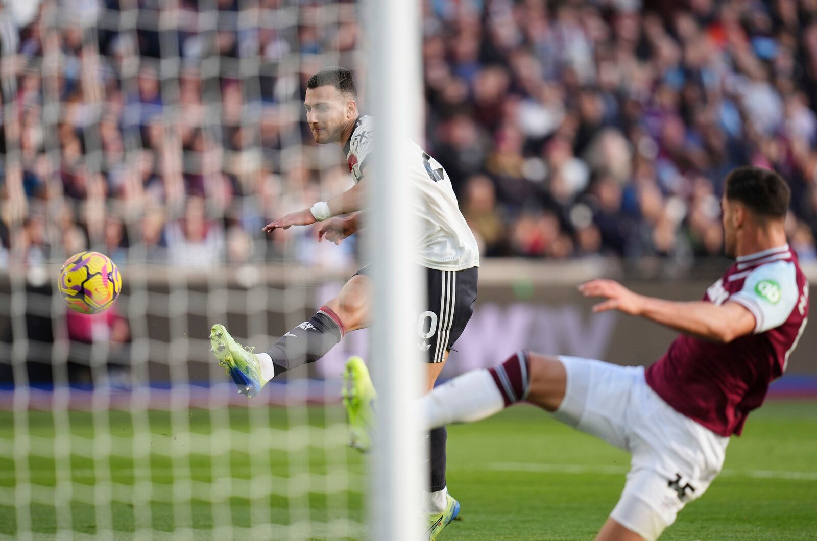 Manchester United's Diogo Dalot, left, misses an opportunity on goal during the English Premier League soccer match between West Ham United and Manchester United at the London Stadium in London, Sunday, Oct. 27, 2024. (John Walton/PA via AP)