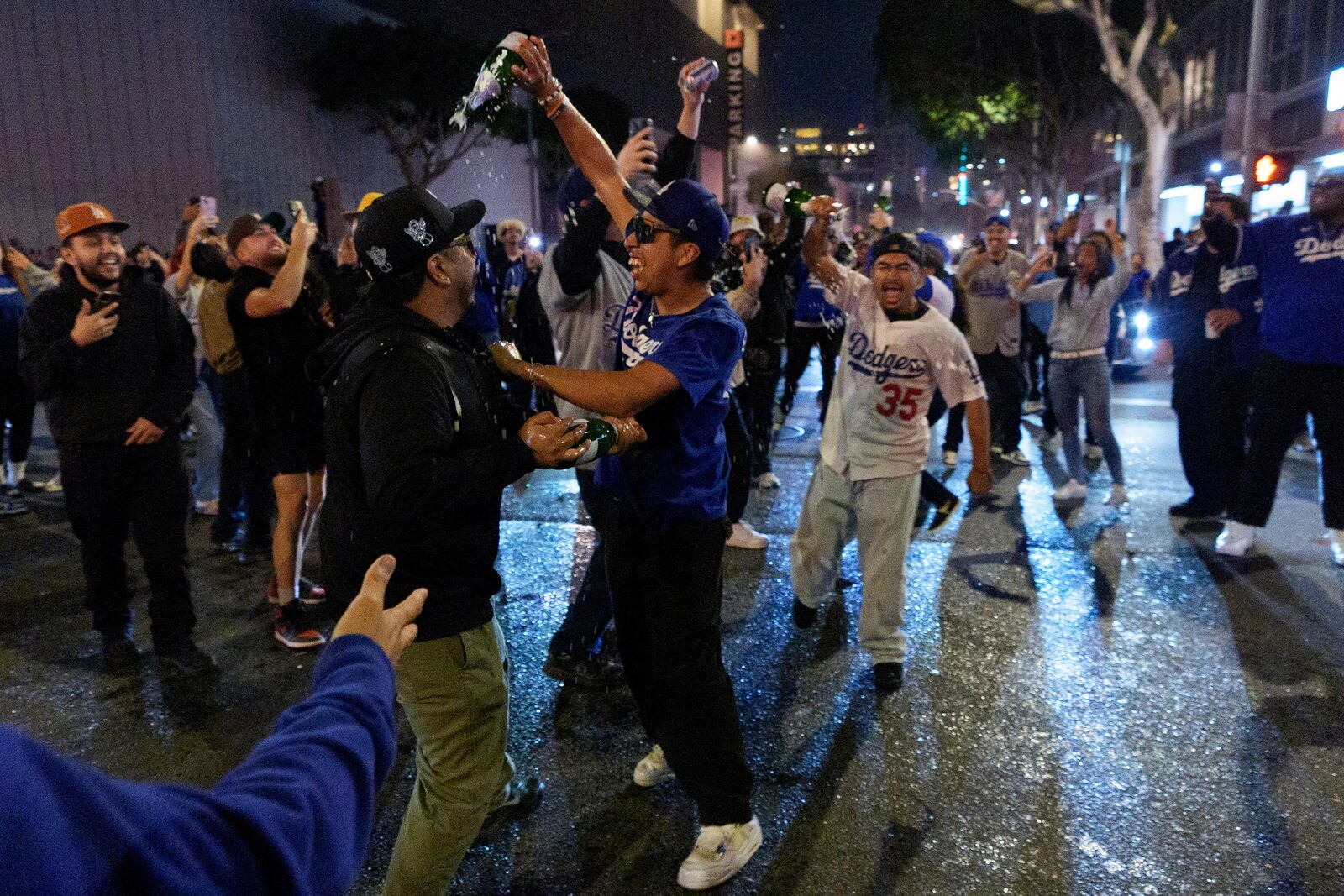 Fans celebrate on the streets after the Los Angeles Dodgers won against the New York Yankees in the baseball World Series Wednesday, Oct. 30, 2024, in downtown Los Angeles. (AP Photo/Damian Dovarganes)