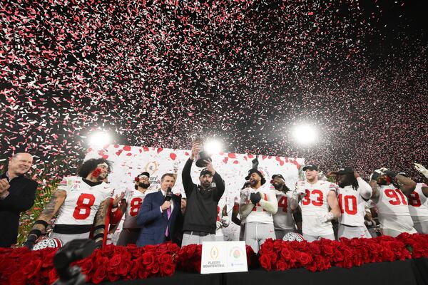 Ohio State head coach Ryan Day holds the trophy as he celebrates with his team after winning the quarterfinals of the Rose Bowl College Football Playoff against Oregon, Wednesday, Jan. 1, 2025, in Pasadena, Calif. (AP Photo/Kyusung Gong)