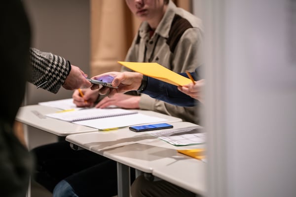 A person arrives to cast their ballot for the Iceland election at a polling station, at Reykjavik city hall, Iceland, Saturday, Nov. 30, 2024. (AP Photo/Marco Di Marco)