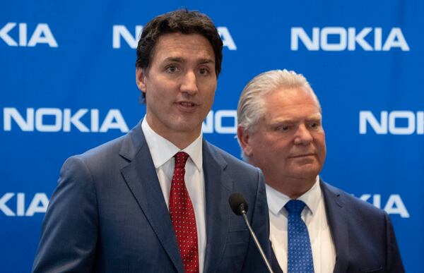 FILE - Prime Minister Justin Trudeau, left, responds to a question as Ontario Premier Doug Ford looks on following an announcement of plans to turn Nokia's Ottawa facility into a research and development technology center in Ottawa, Ontario, on Monday, Oct. 17, 2022. (Adrian Wyld/The Canadian Press via AP, File)tariff