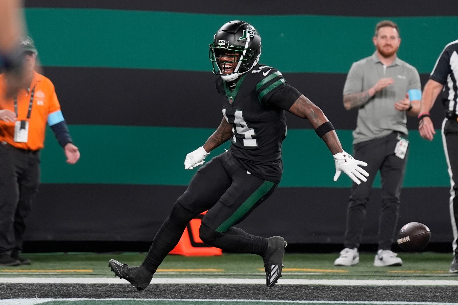 New York Jets wide receiver Malachi Corley drops the football before scoring a touchdown during the first half an NFL football game against the Houston Texans, Thursday, Oct. 31, 2024, in East Rutherford, N.J. (AP Photo/Seth Wenig)