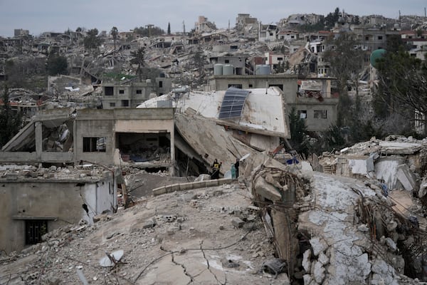 Lebanese citizens check the destruction caused by the Israeli air and ground offensive, in Aita al-Shaab, a Lebanese border village with Israel, south Lebanon, Sunday, Jan. 26, 2025. (AP Photo/Bilal Hussein)