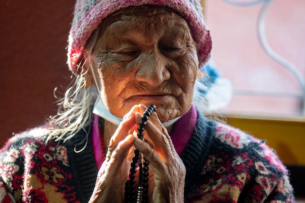 A Tibetan woman offers a prayer in the remembrance of those who lost their lives in the recent earthquake, at a Tibetan camp in Lalitpur, Nepal, on Wednesday, Jan. 8, 2025. (AP Photo/Niranjan Shrestha)