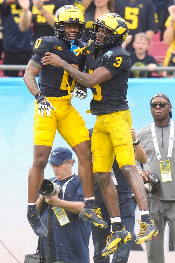 Michigan wide receiver Fredrick Moore (3) celebrates his touchdown against Alabama with wide receiver Semaj Morgan during the first half of the ReliaQuest Bowl NCAA college football game Tuesday, Dec. 31, 2024, in Tampa, Fla. (AP Photo/Chris O'Meara)