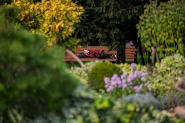 FILE - A man sleeps on a bench in a park in Chisinau, Moldova, Friday, Oct. 18, 2024. (AP Photo/Vadim Ghirda, File)