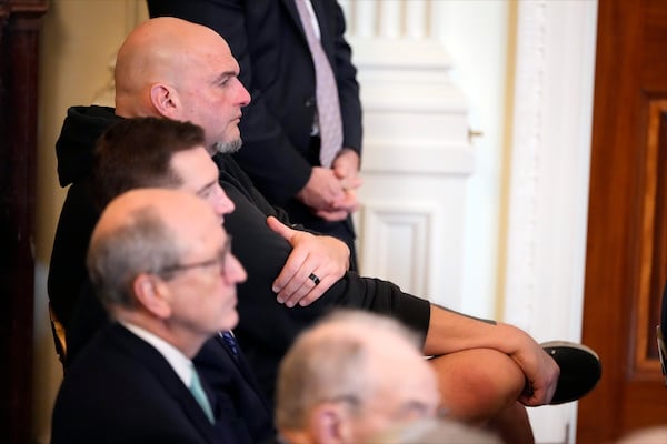 Sen. John Fetterman, D-Pa., listens as President Donald Trump speaks before signing the Laken Riley Act in the East Room of the White House, Wednesday, Jan. 29, 2025, in Washington. (AP Photo/Alex Brandon)