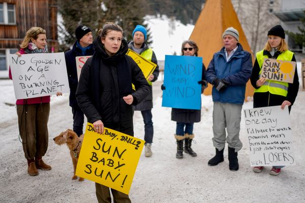 Climate activist Luisa Neubauer, front, takes part in a small protest at the Annual Meeting of World Economic Forum in Davos, Switzerland, Wednesday, Jan.22, 2025. (AP Photo/Markus Schreiber)