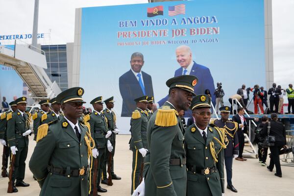 A poster showing President Joe Biden and Angola's President Joao Lourenco is seen during a welcome ceremony at Catumbela airport in Angola on Wednesday, Dec. 4, 2024. (AP Photo/Ben Curtis)