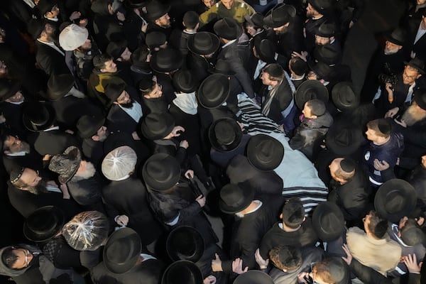 The body of Israeli-Moldovan rabbi Zvi Kogan is carried from a funeral home before his burial in Jerusalem, early Tuesday Nov. 26, 2024. Kogan, 28, an ultra-Orthodox rabbi, was killed last week in Dubai where he ran a kosher grocery store. Israelis have flocked for commerce and tourism since the two countries forged diplomatic ties in the 2020 Abraham Accords.(AP Photo/Mahmoud Illean)