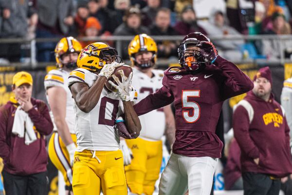 Minnesota wide receiver Le'Meke Brockington (0) makes a catch past Virginia Tech cornerback Joshua Clarke (5) during the first half of the Duke's Mayo Bowl NCAA college football game Friday, Jan. 3, 2025, in Blacksburg, Va. (AP Photo/Robert Simmons)