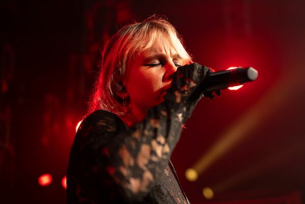 Iryna Panchuk, solo singer of indie rock band Renie Cares sings during the presentation of the music album Epoch, a collaboration between Ukrainian artists and the 3rd Assault Brigade, in Kyiv, Ukraine, Saturday, Dec. 7, 2024. (AP Photo/Alex Babenko)