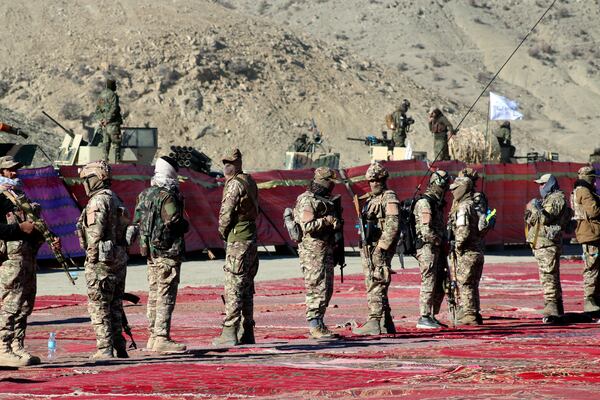 Taliban fighters stand guard during the funeral prayers of Khalil Haqqani, the minister for refugees and repatriation, during his funeral procession in eastern Paktia province, Afghanistan, Thursday, Dec. 12, 2024.(AP Photo/Saifullah Zahir)