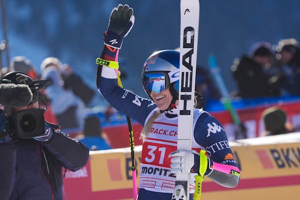 United States' Lindsey Vonn celebrates at the finish area of an alpine ski, women's World Cup super G, in St. Moritz, Switzerland, Saturday, Dec. 21, 2024. (AP Photo/Giovanni Auletta)