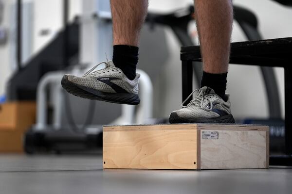 Jacob Bullard steps off a box as part of his physical therapy at WashU, Monday, Dec. 16, 2024, in St. Louis. (AP Photo/Jeff Roberson)