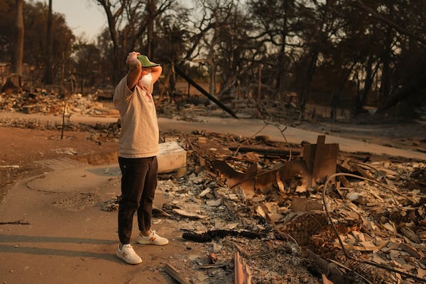 A man reacts to encountering the remains of a fire-ravaged property in the aftermath of the Eaton Fire Thursday, Jan. 9, 2025 in Altadena, Calif. (AP Photo/Eric Thayer)