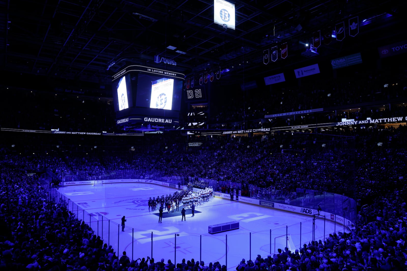 Blue Jackets' Johnny Gadreau's family watches a #13 banner being raised during a ceremony before the start of an NHL hockey game between the Columbus Blue Jackets and the Florida Panthers. Tuesday, Oct. 15, 2024, in Columbus, Ohio. (AP Photo/Jay LaPrete)