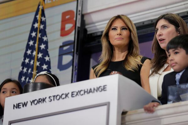 FILE - New York Stock Exchange President Stacey Cunningham, right, and first lady Melania Trump, with the help of students from the United Nations International School, ring the opening bell of the NYSE in New York, Sept. 23, 2019. (AP Photo/Seth Wenig, File)