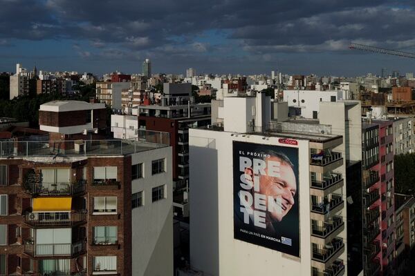 A poster of Alvaro Delgado, presidential candidate for the ruling National Party, covers a building ahead of the presidential run-off election in Montevideo, Uruguay, Friday, Nov. 22, 2024. (AP Photo/Natacha Pisarenko)