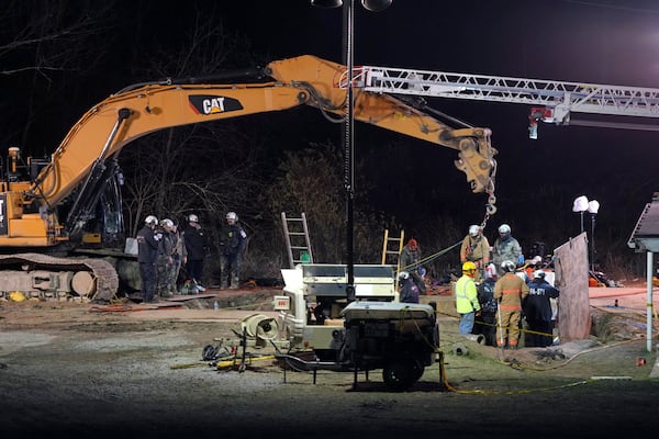 Rescue workers search through the night in a sinkhole for Elizabeth Pollard, who disappeared while looking for her cat, in Marguerite, Pa., Tuesday, Dec. 3, 2024. (AP Photo/Gene J. Puskar)