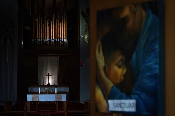 A painting with the word "sanctuary" on it is displayed on the doors of the Augustana Lutheran Church on Thursday, Jan. 9, 2025, in Portland, Ore. (AP Photo/Jenny Kane)