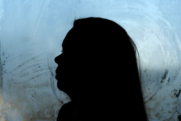 Roselins Sequera looks out the front door of her home, Monday, Dec. 9, 2024, in Marshalltown, Iowa. (AP Photo/Charlie Neibergall)