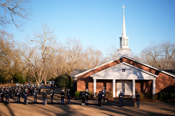 An honor guard and honor guard band march before the casket of former President Jimmy Carter arrives at Maranatha Baptist Church for a funeral service, Thursday, Jan. 9, 2025, in Plains, Ga. (AP Photo/Mike Stewart)