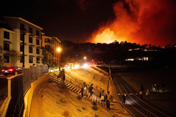 Students evacuate from Pepperdine University as the Franklin Fire burns in Malibu, Calif., on Tuesday, Dec. 10, 2024. (AP Photo/Ethan Swope)