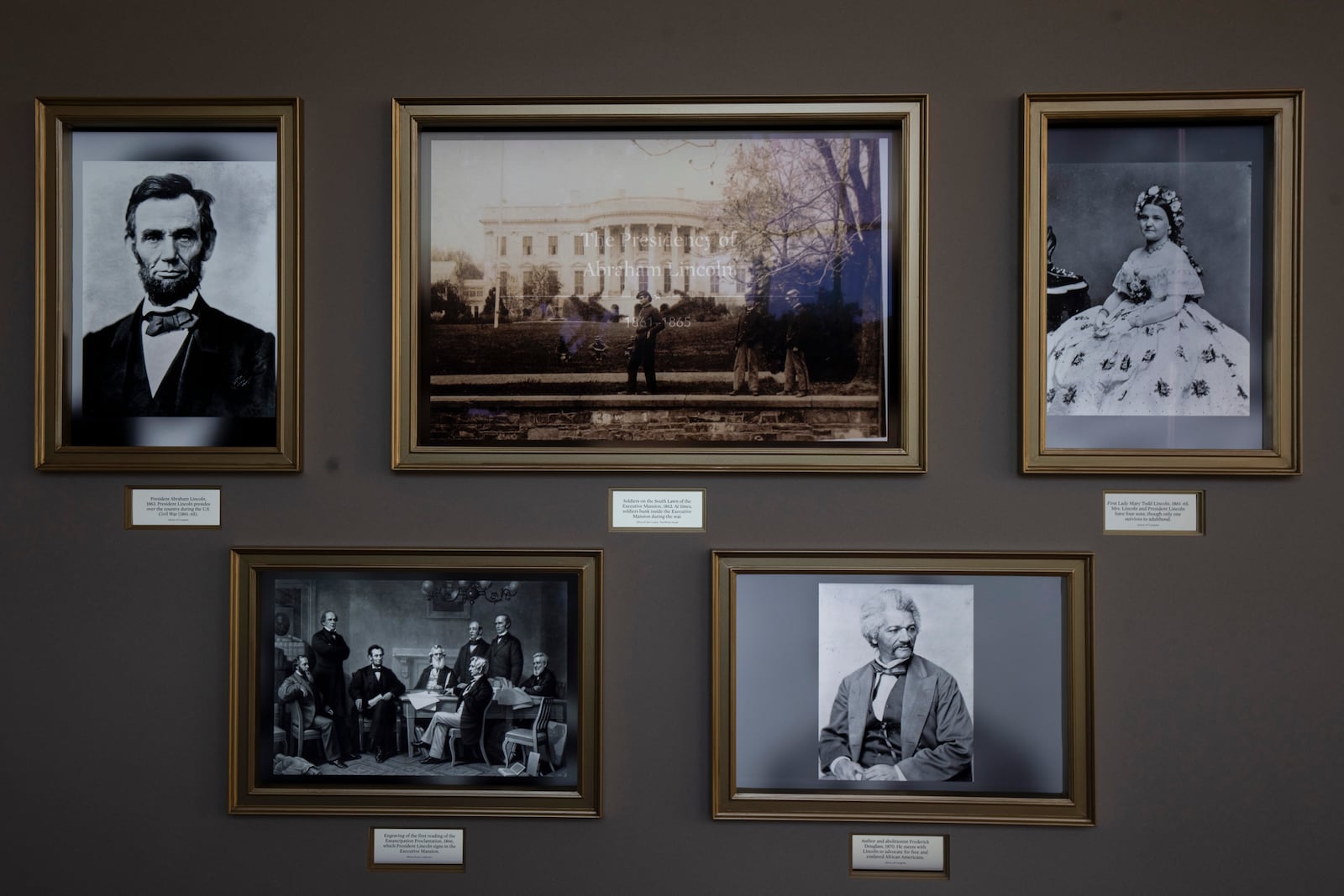 Collages of printed photos that line the hallway and changes picture display every minute, shows on Friday, Oct. 18, 2024 in Washington, a picture of President Abraham Lincoln and related pictures during his presidency. (AP Photo/Manuel Balce Ceneta)