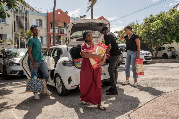 People bring goods for victims of cyclone Chido in Mayotte at the House of Mayotte, in Saint-Denis, Réunion Island, Wednesday, Dec. 18, 2024. (AP Photo/Adrienne Surprenant)