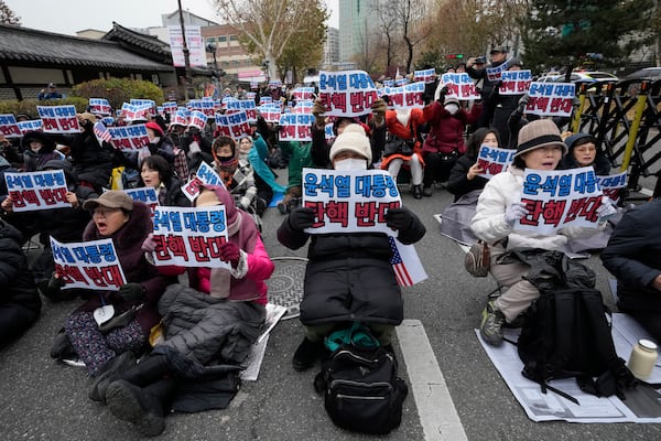 Supporters for impeached South Korean President Yoon Suk Yeol stage rally against his impeachment near the Constitutional Court in Seoul, South Korea, Monday, Dec. 16, 2024. The signs read "Oppose the impeachment of President Yoon Suk Yeol." (AP Photo/Ahn Young-joon)