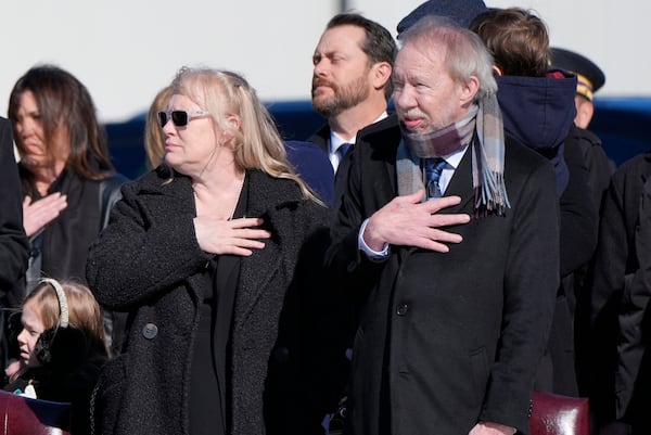 Amy Carter and Jeff Carter watch as the flag-draped casket of former President Jimmy Carter is placed on Special Air Mission 39 at Dobbins Air Reserve Base in Marietta, Ga., Tuesday, Jan. 7, 2025. Carter died Dec. 29 at the age of 100. (AP Photo/Alex Brandon, Pool)