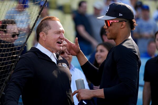 New York Yankees' Juan Soto talks with agent Scott Boras before Game 1 of the baseball World Series against the Los Angeles Dodgers, Friday, Oct. 25, 2024, in Los Angeles. (AP Photo/Julio Cortez)