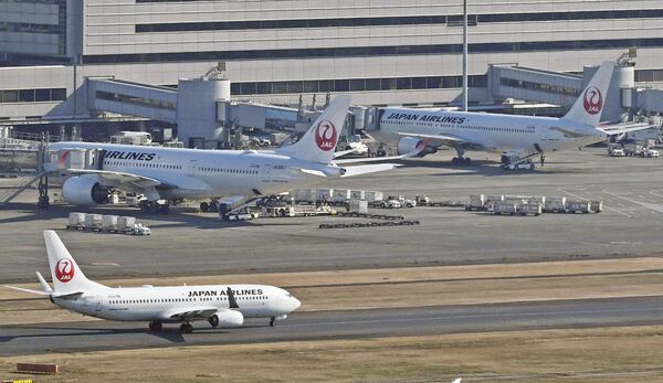 Japan Airlines aircraft are seen at Tokyo's Haneda airport Thursday, Dec. 26, 2024, after the airlines said it was hit by a cyberattack. (Kyodo News via AP)