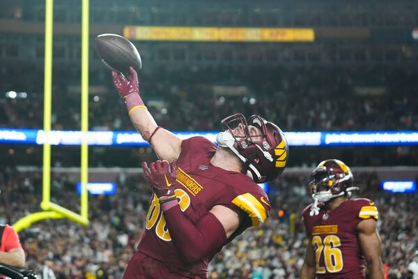 Washington Commanders tight end Zach Ertz (86) celebrates his touchdown reception during the second half of an NFL football game against the Atlanta Falcons, Sunday, Dec. 29, 2024, in Landover, Md. (AP Photo/Stephanie Scarbrough)