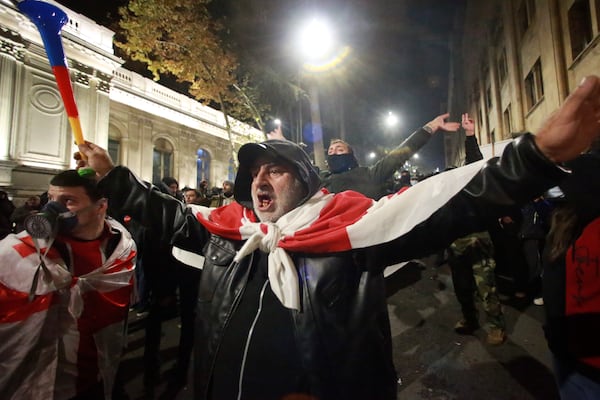 Demonstrators shout standing in front of police during a rally outside the parliament's building to protest the government's decision to suspend negotiations on joining the European Union for four years in Tbilisi, Georgia, on Saturday, Nov. 30, 2024. (AP Photo/Zurab Tsertsvadze)