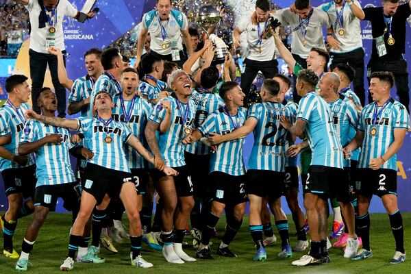 Players of Argentina's Racing Club celebrate with the trophy after winning the Copa Sudamericana final soccer match against Brazil's Cruzeiro in Asuncion, Paraguay, Saturday, Nov. 23, 2024. (AP Photo/Jorge Saenz)