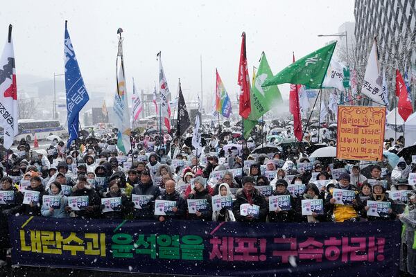 Protesters stage a rally demanding the arrest of impeached South Korean President Yoon Suk Yeol near the presidential residence in Seoul, South Korea, Sunday, Jan. 5, 2025. The letters read "Arrest Yoon Suk Yeol." (AP Photo/Ahn Young-joon)