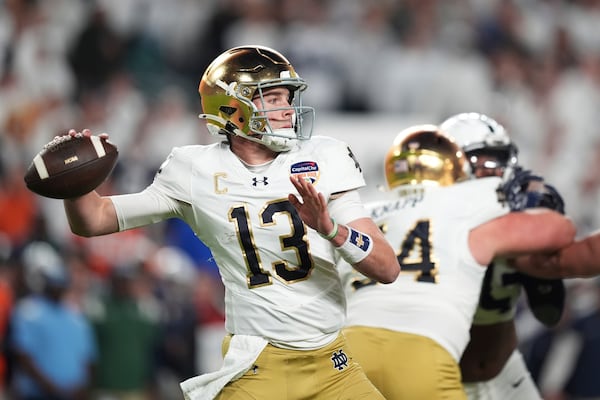 Notre Dame quarterback Riley Leonard (13) aims a pass during first half of the Orange Bowl NCAA College Football Playoff semifinal game against Penn State, Thursday, Jan. 9, 2025, in Miami Gardens, Fla. (AP Photo/Rebecca Blackwell)