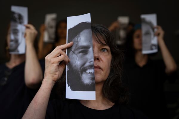 FILE.- Relatives and supporters of Israeli hostages held by Hamas in Gaza hold photos of their loved ones during a performance calling for their return in Tel Aviv, Israel, Thursday, May 23, 2024. (AP Photo/Oded Balilty,File)