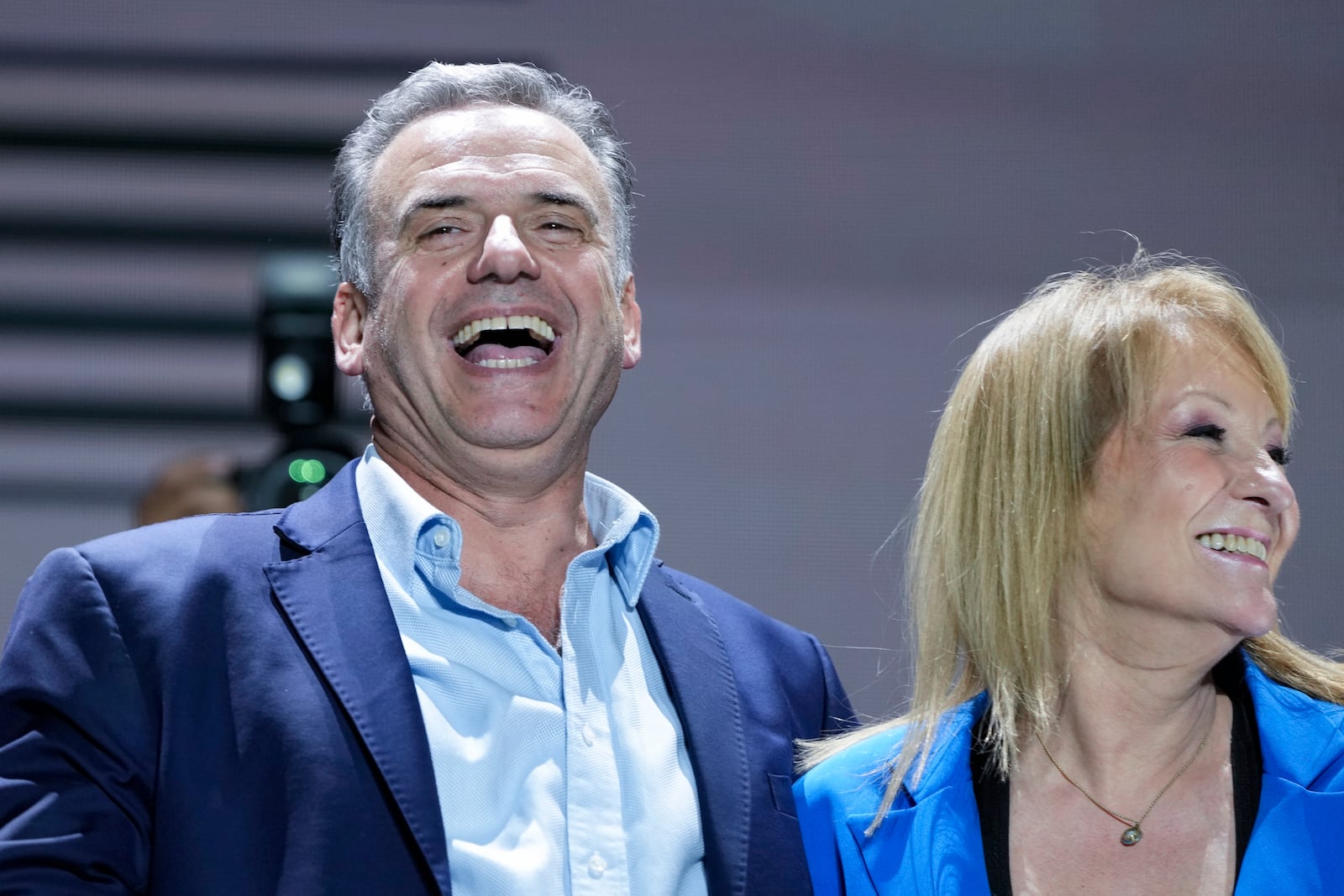 Frente Amplio presidential candidate Yamandu Orsi and running mate Carolina Cosse smile to supporters outside of a hotel after general elections polls closed in Montevideo, Uruguay, Sunday, Oct. 27, 2024. (AP Photo/Natacha Pisarenko)