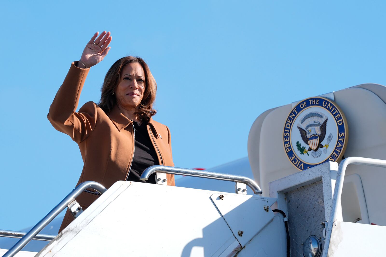 Democratic presidential nominee Vice President Kamala Harris waves as she boards Air Force Two at William P. Hobby Airport in Houston, Saturday, Oct. 26, 2024. (AP Photo/Susan Walsh)