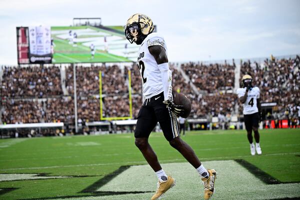 FILE - Colorado wide receiver Travis Hunter (12) celebrates his touchdown catch during the first half of an NCAA college football game against Central Florida, Saturday, Sept. 28, 2024, in Orlando, Fla. (AP Photo/Phelan M. Ebenhack, File)