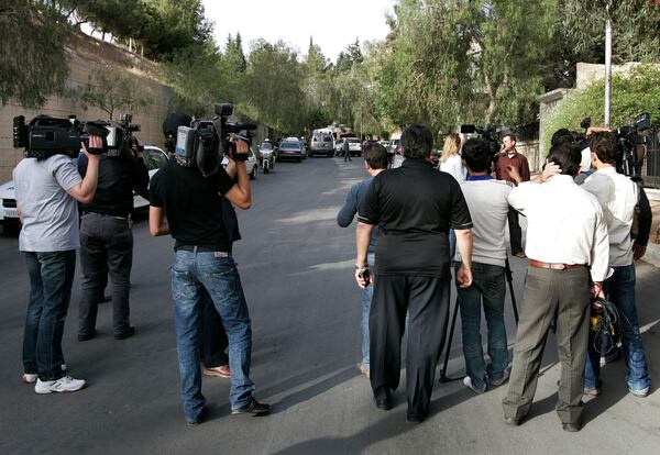 FILE - Syrian cameramen and journalists wait after they were prevented from covering a meeting between former U.S. President Jimmy Carter and Hamas political leader Khaled Mashaal in Damascus, Syria, on April 18, 2008. (AP Photo/Hussein Malla, File)